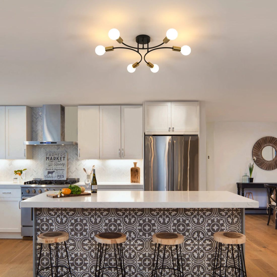 Sleek black and gold chandelier enhancing the ambiance of a contemporary kitchen with a large island.