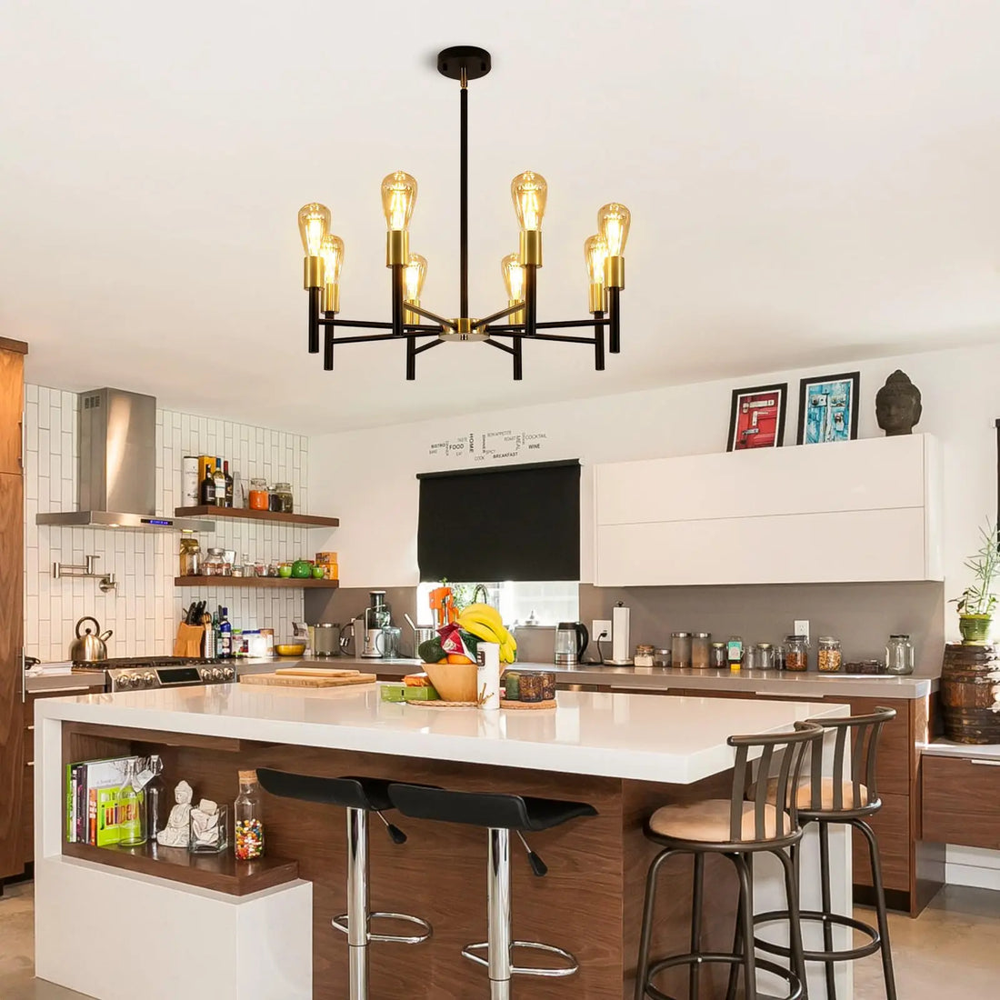 Black and gold chandelier installed in a modern kitchen with white cabinets and wooden elements.