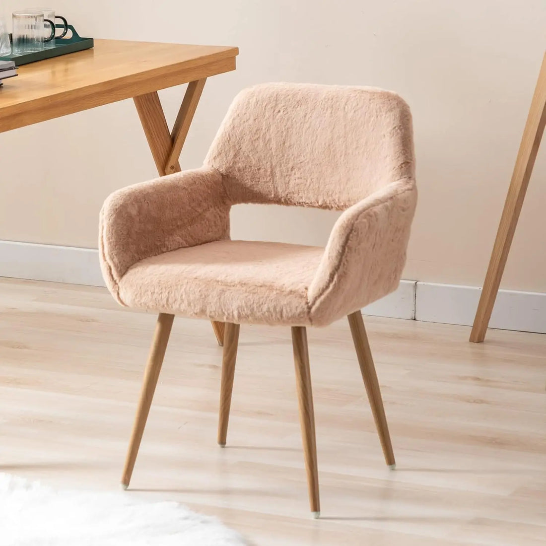 Front-angle view of an SSLine faux fur vanity chair in a camel color, featuring a modern comfy arm design and wooden legs near a makeup desk.