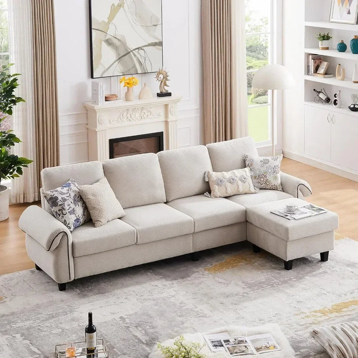 Another view of the beige L-shaped sectional sofa with throw pillows and a coffee table, featuring a large window with a garden view.
