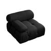 Black tufted U-shaped sectional sofa with a comfortable ottoman and soft cushions.