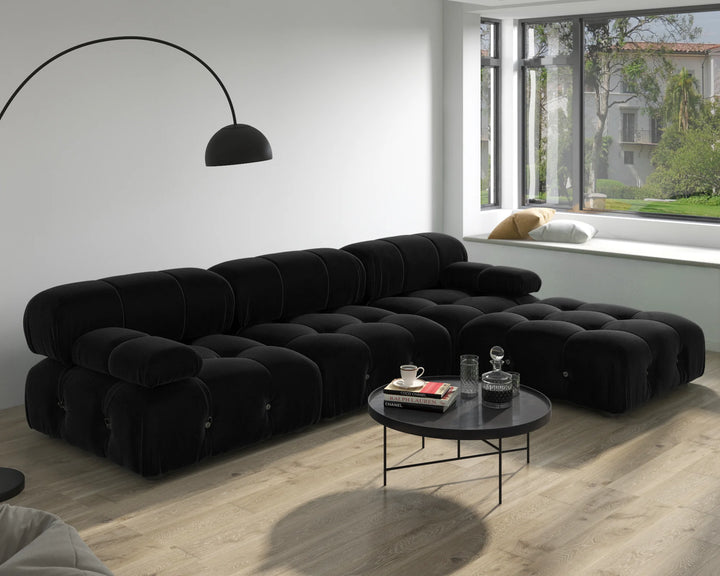 Modern U shaped sectional sofa in black with ottomans creating a cozy and elegant living room space.